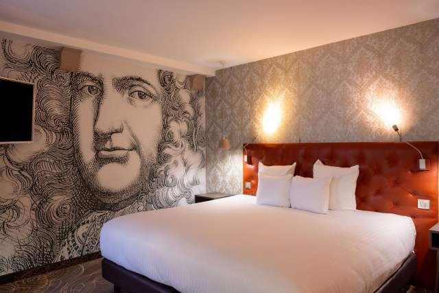 Chambre double avec fresque murale portrait et literie rouge, hébergement Hôtel l'Orchidée Ensisheim